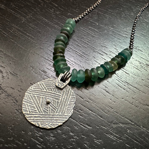 ORIJEN'S: Silver Reversible Textured Disc Necklace with Roman Glass