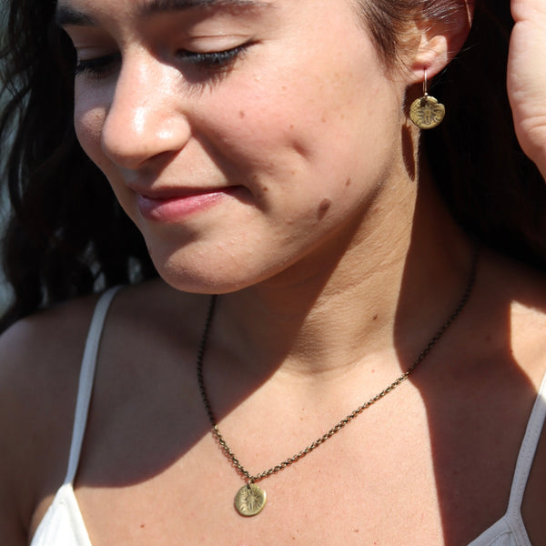 ORIJEN'S: Tiny Brass Sand Dollar Necklace